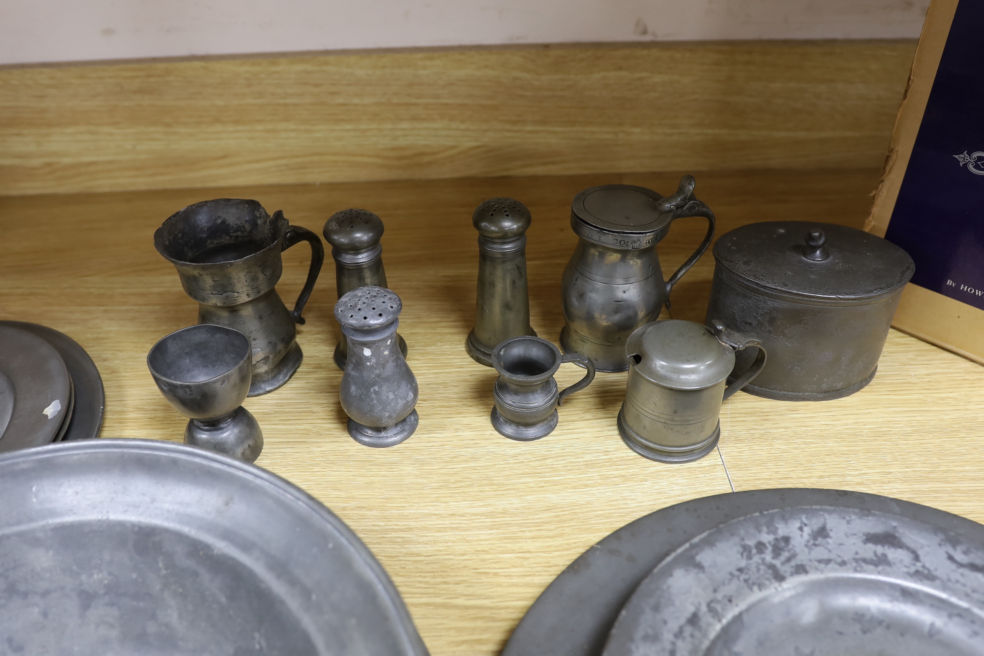Pewter ware; a collection of plates, spoon cruet, jug, box, a large bowl, etc., bowl 34cm diameter (19)